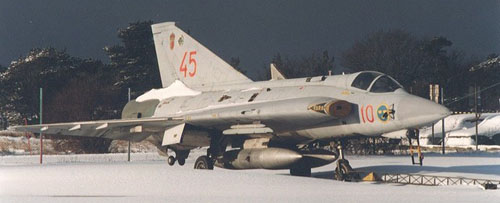 A grey Draken is covered by snow