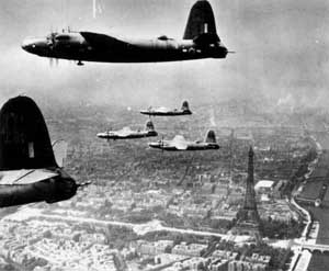 The Eiffel Tower can be seen below a formation of B-26's