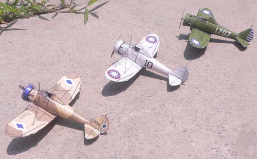 Three Boeing P-26 Peashooters are lined up. One is from the Philippines, the other two from China