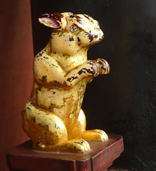 This is a wooden rabbit statue, carved on the top of a railing